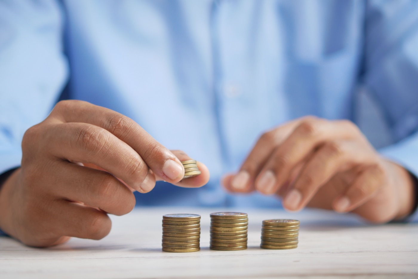 A person counting change to save up for getting a website