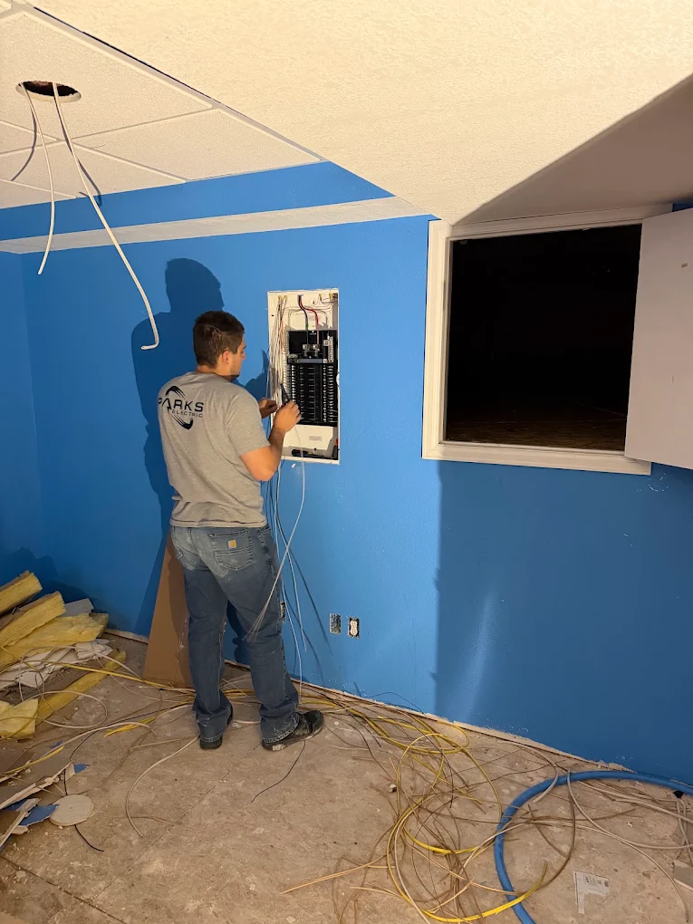 A Parks Electric electrician wiring a breaker panel on a Highlands Ranch job site